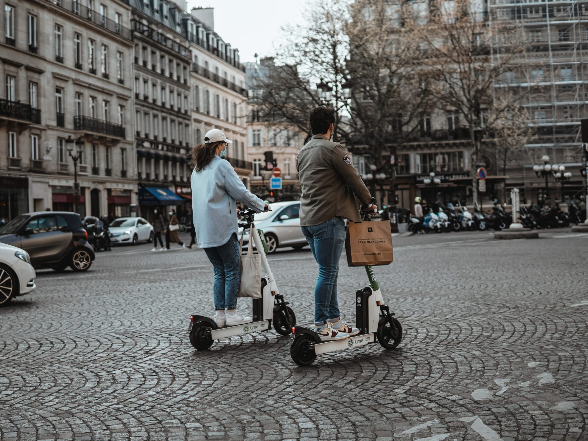 Woman and man on electric scooters. Photo by Vlad B on Unsplash.